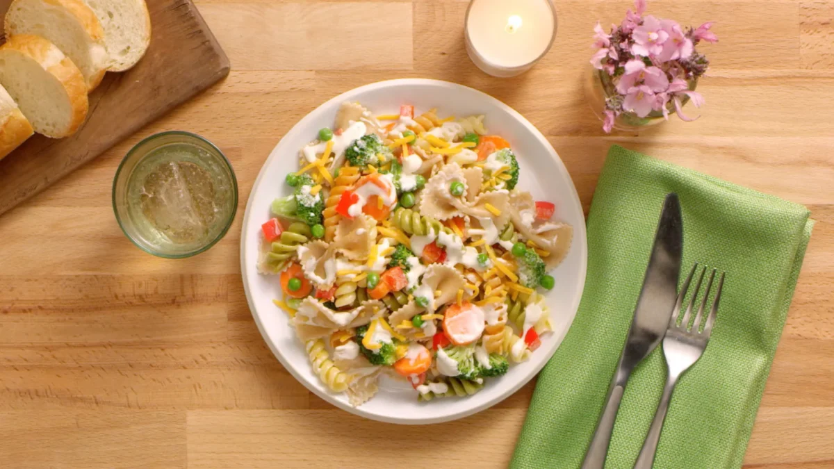 Ranch pasta salad 14 a delicious ranch pasta salad, highlighting pasta, fresh veggies, and a rich dressing in a bowl.