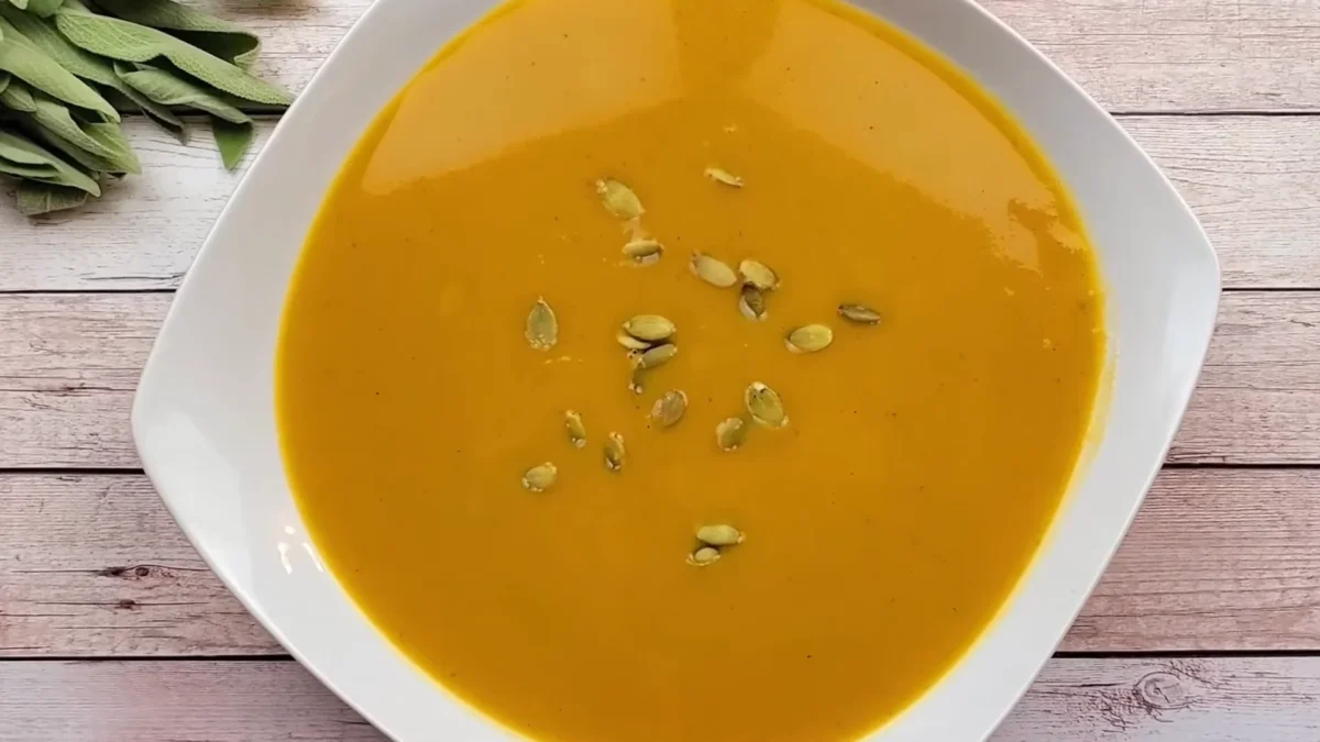 Roasted Butternut Squash Soup 11 Serve Creamy roasted butternut squash soup garnished with a sprinkle of herbs and a drizzle of olive oil in a rustic bowl.