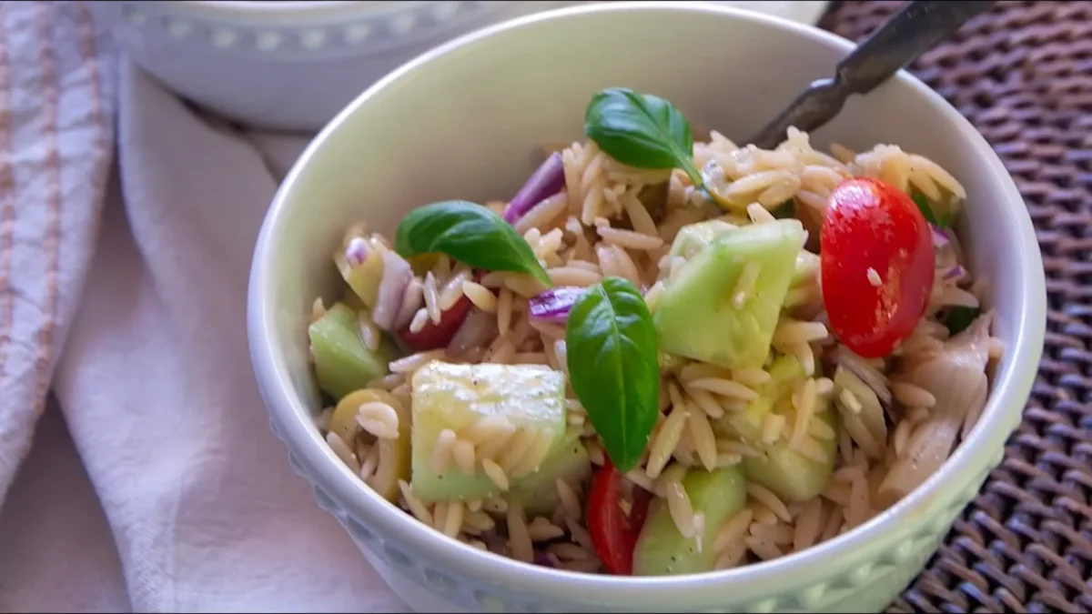 Spinach Greek Orzo Salad 9 Serve or Chill A delicious Spinach Greek Orzo Salad showcasing fresh spinach, diced tomatoes, olives, and feta cheese, beautifully arranged.